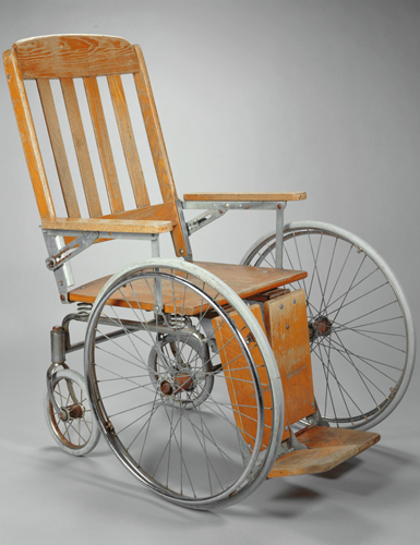 A wood and steel wheelchair
